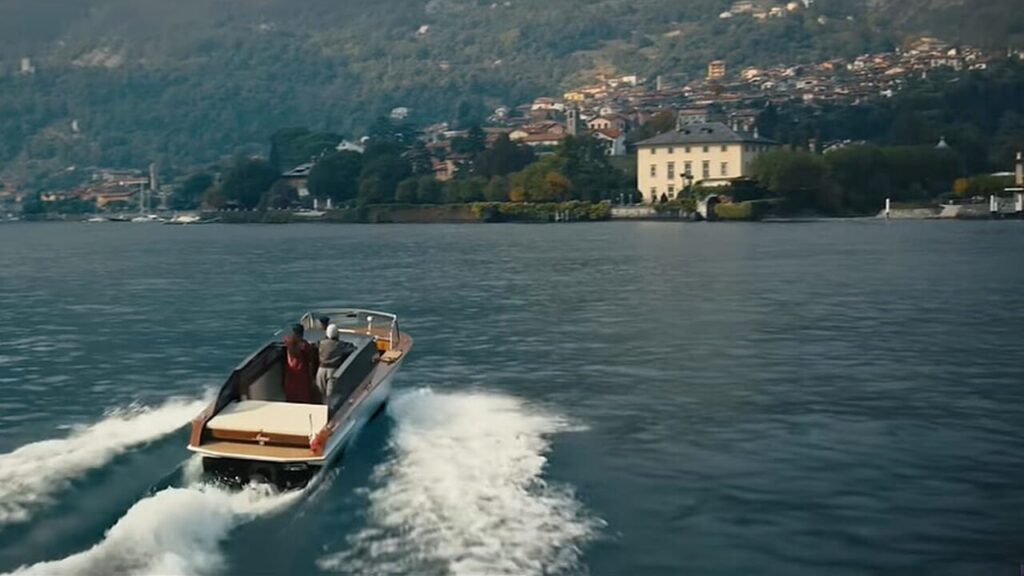 Boat crossing Lake Como with Villa Balbiano in the background during a cinematic scene in Italy