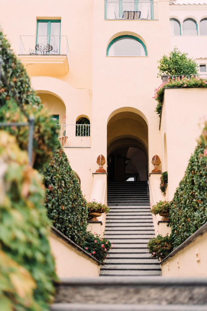 Amalfi Coast Wedding Videographer 2 Luxury Amalfi Coast villa staircase surrounded by Mediterranean greenery, pastel architecture, and romantic Italian wedding atmosphere.