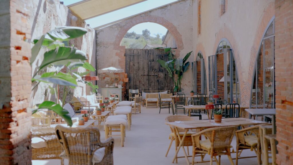 Elegant courtyard interior at La Pescaia Resort in Tuscany with rustic architecture and luxury lounge seating.
