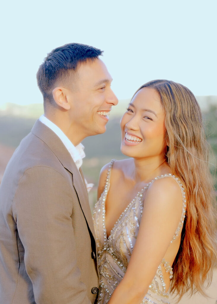 Happy couple embracing during a romantic golden hour wedding portrait in Italy.