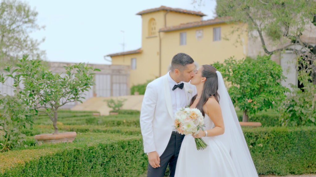 Wedding Videographer Florence in Italy 2 Bride and groom sharing a kiss in the Italian garden of Villa di maiano, Florence — luxury wedding film by Giancarlo De Vita