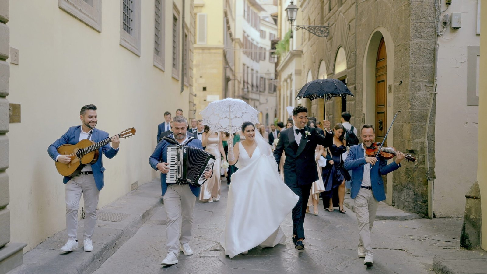 Wedding Videographer Florence in Italy 1 Bride and groom walking through the streets of Florence with live musicians during wedding procession — luxury wedding film by Giancarlo De Vita