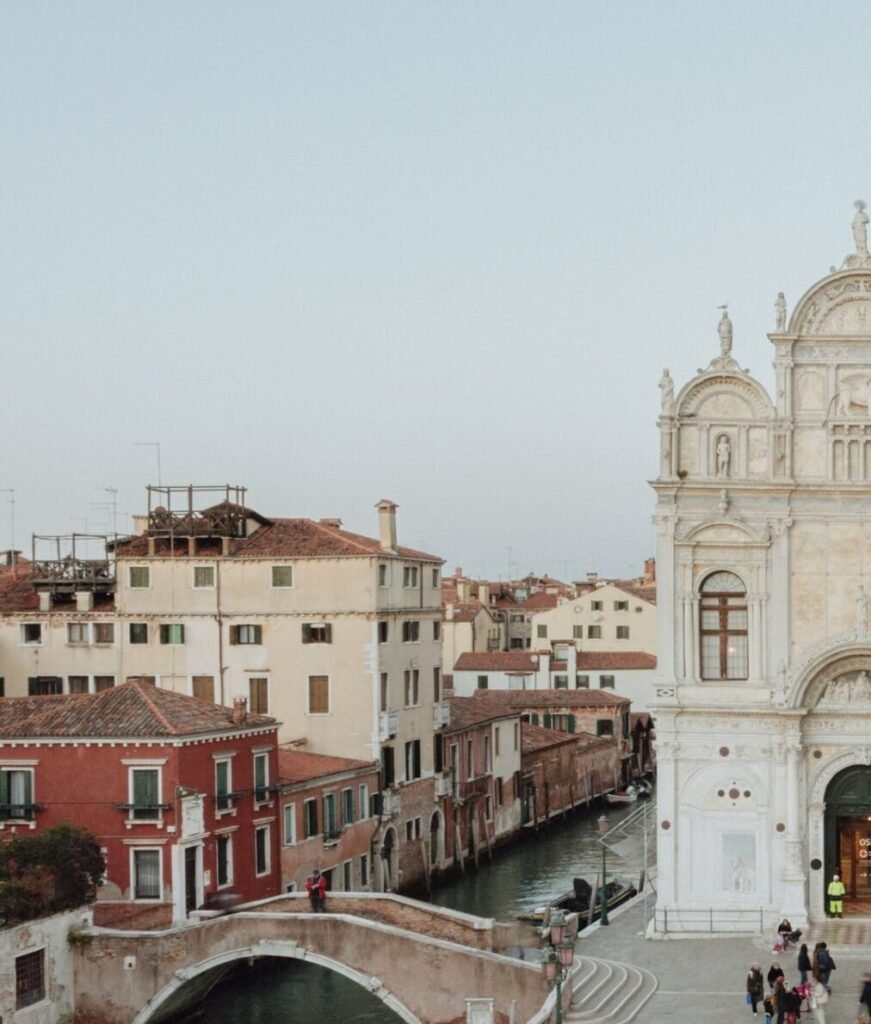 Italy Wedding videographer 4 Venice wedding location with a canal, stone bridge and Renaissance marble façade at dusk
