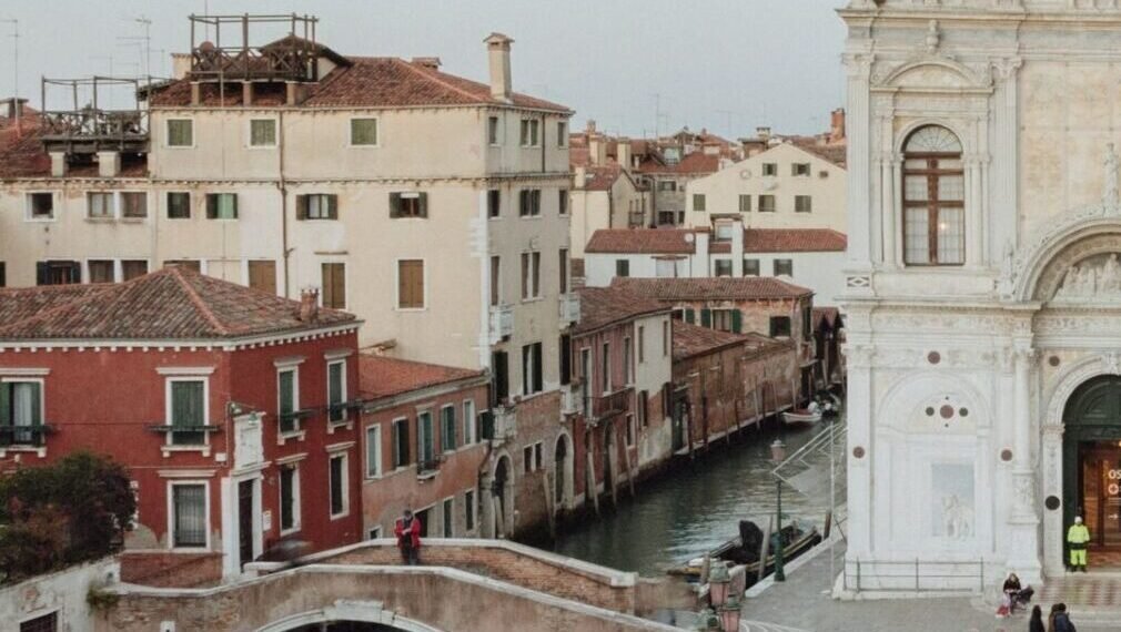 Venice wedding location with a canal, stone bridge and Renaissance marble façade at dusk