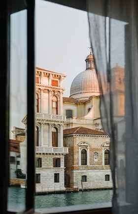 Wedding Videographer Venice 1 Luxury wedding videographer Venice — Grand Canal view from a palazzo window, echoing Palazzo Pisani Moretta's frescoed rooms