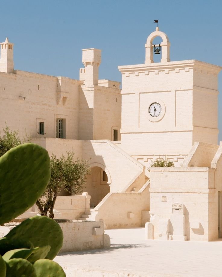 Wedding Videographer Puglia 2 Whitewashed clock tower and stone architecture at Borgo Egnazia wedding venue in Puglia